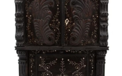 A Continental Diminutive Carved and Inlaid Cabinet