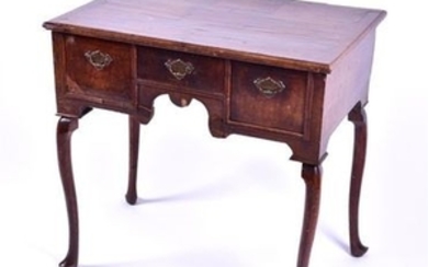 A Georgian walnut lowboy with three front drawers with engraved brass backplates and moulded edges, supported on cabriole...