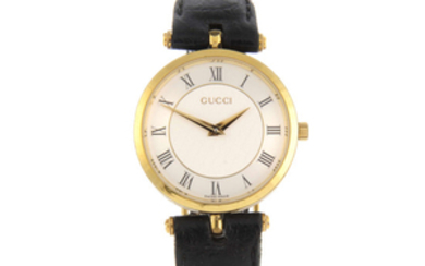 GUCCI - a mid-size gold plated wrist watch with two Gucci wrist watches.