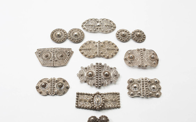 Ten filigree silver buckles and a pair of buttons