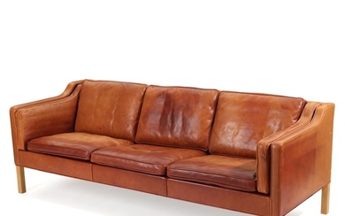 Børge Mogensen: A three-seater sofa with oak legs, upholstered with cognac coloured leather. Manufactured by Fredericia Stolefabrik. L. 221 cm.