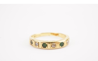 A 18ct gold diamond and emerald set ring half eternity ring....