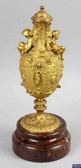 A 19th century gilt metal pedestal vase decorated with winged cherubs.