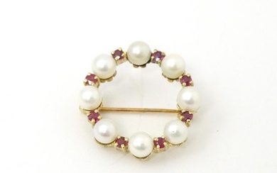 A 9ct gold pendant / brooch of circular set with pearls and ...