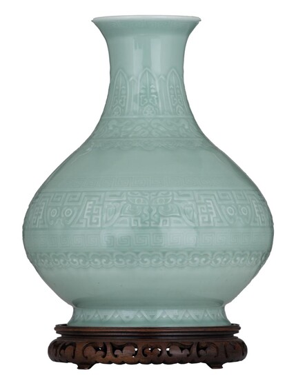 A Chinese archaistic Anhua celadon-glazed bottle vase, with...