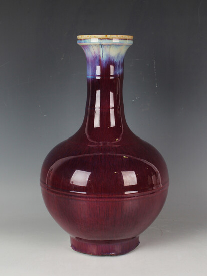 A Chinese flambé glazed bottle vase, Qing dynasty, possibly 18th century, the globular body wit