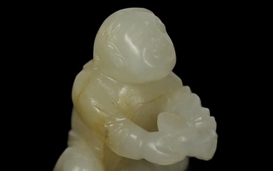 * * A Chinese white and russet carved jade figure of Liu Hai...