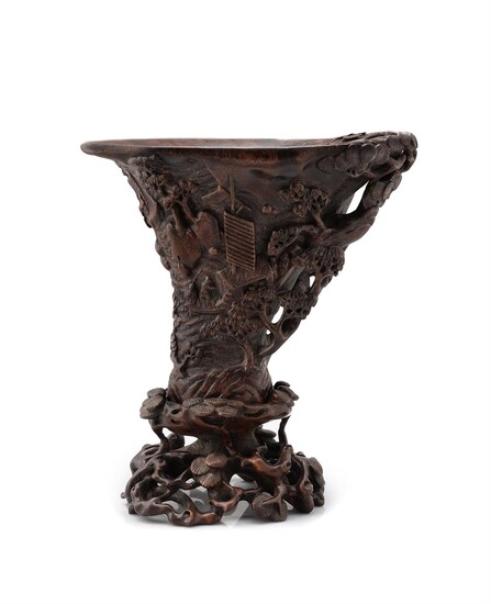 A Chinese wood carved libation cup and stand