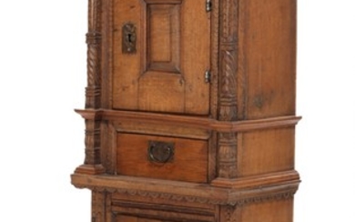 A Danish 17th century Renaissance oak cabinet. Front with two doors and a drawer. Carved with biblical quote. H. 143. W. 53. D. 33 cm.