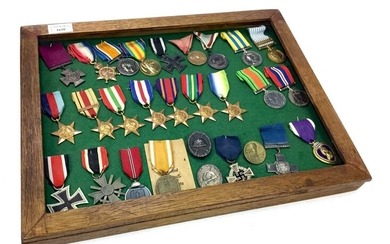 A FRAMED GROUP OF BRITISH AND GERMAN WWI AND WWII MEDALS