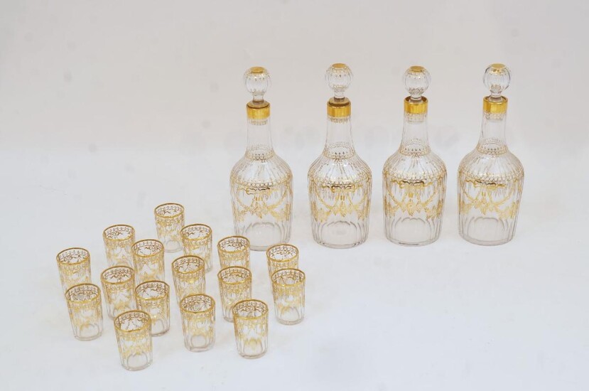A French gilt-decorated gilt-heightened glass part liqueur set, second half 20th century, comprising: four faceted decanters and stoppers, 22cm high; and sixteen faceted glasses, 5cm high (20)