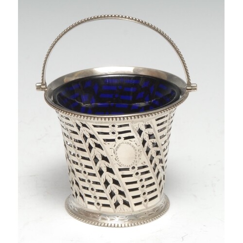 A George III silver swing handled cream basket, pierced and ...