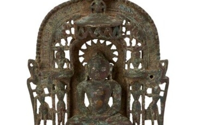 A Jain brass alter piece, Western India, 19th century, cast with a jina seated in meditation on a throne supported by rubbed figures, surrounded by seated or standing figures of tirthankaras, the back inscribed in davanagari script, on an openwork...