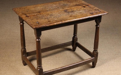 A Late 17th/Early 18th Century Centre Table. The planked top with bevelled ends standing on turned c