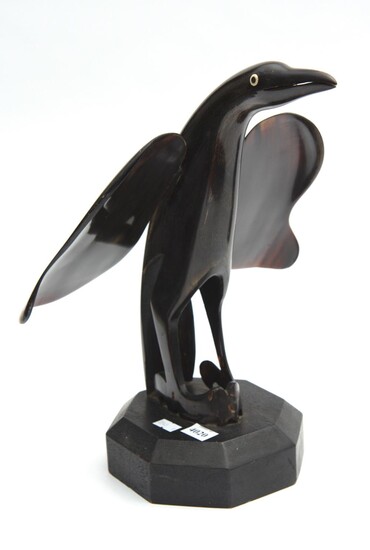 A MID-CENTURY PENGUIN FIGURE HORN ON WOODEN STAND