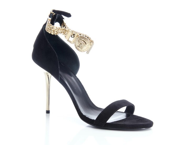 A PAIR OF HEELS BY VERSACE - Styled in black suede with gold metal Medusa head ankle strap and gold metal heel, labelled size 41, bo...