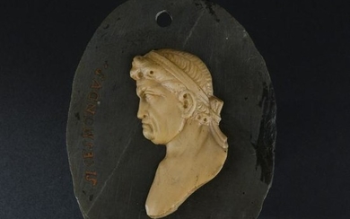 A Roman black marble and giallo di Siena oval medallion