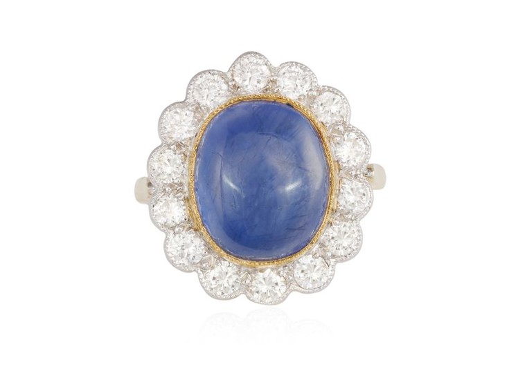 A SAPPHIRE AND DIAMOND CLUSTER RING, The oval-shaped...
