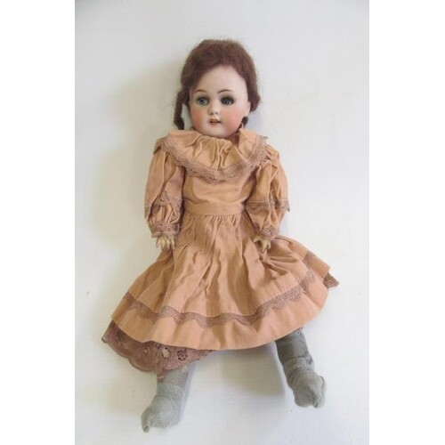 A Simon & Halbig bisque socket head doll, with blue glass sl...