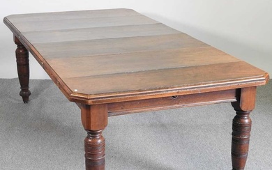 A Victorian mahogany wind-out extending dining table, on turned legs...