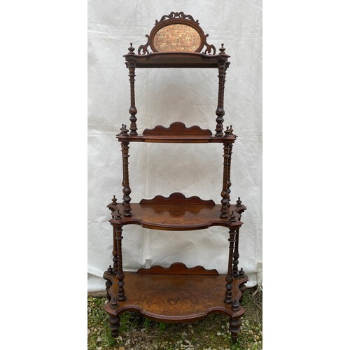 A Victorian walnut four tier graduating what-not with oval m...