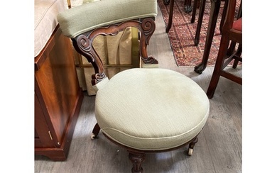 A Victorian walnut nursing chair with pistachio green uphols...