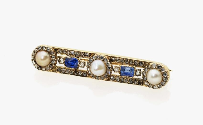 A brooch with diamonds, pearls, rubies and sapphires
