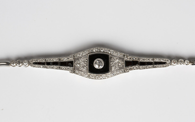 A diamond and black onyx bracelet, circa 1930, collet set with the principal cushion cut diamond to