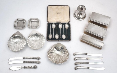 A group of silver and silver plate, comprising: two silver scallop shell dishes, London 1899, 12.7cm deep; a cased set of six silver coffee spoons, Sheffield, 1928, Mappin & Webb; a filled silver candlestick, Chester, 1908, Martin, Hall & Co, 7.5cm...