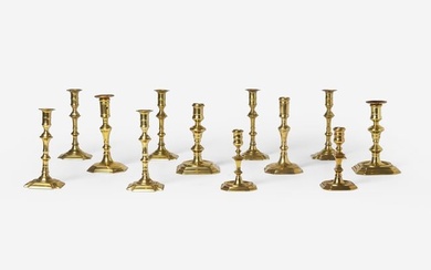 A group of twelve Chippendale octagonal or notched base brass candlesticks, England, late 18th
