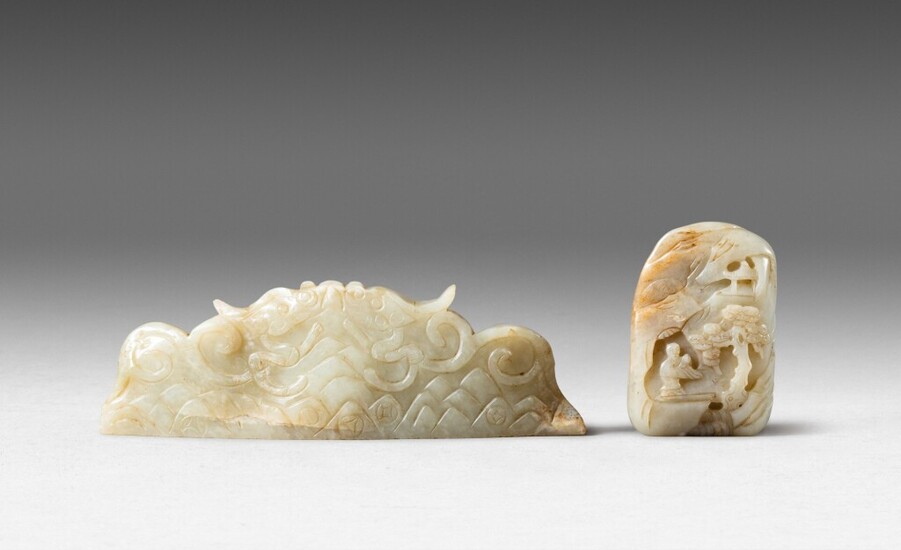 A jade mountain-shaped brush rest and a white and russet jade pebble Ming dynasty and Qing dynasty, 17th century | 明 玉龍紋筆擱 及 清十七世紀 白玉山子 一組兩件