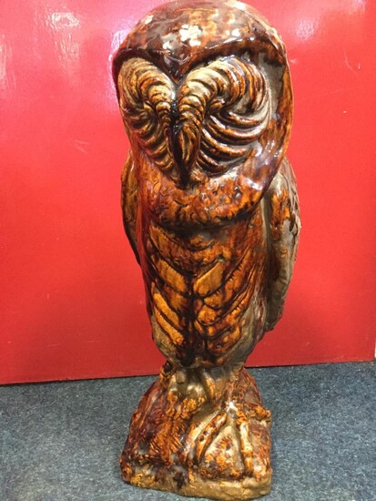 A large treacle glazed terracotta owl, the bird modelled...