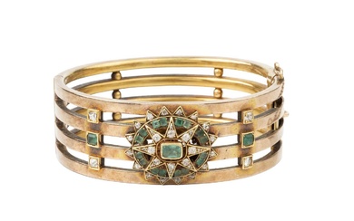 A late 19th century diamond and emerald set hinged bangle,...
