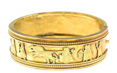 A late Victorian 15ct gold Assyrian Revival hinged bangle.