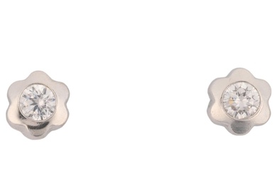 A pair of 0.2ct solitaire diamond flowerhead earrings, each ...