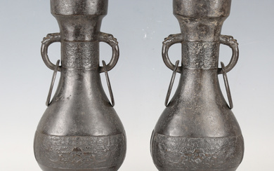 A pair of Chinese archaistic brown patinated bronze hu vases, Ming dynasty, each pear-form body cast