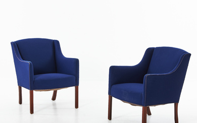 A pair of Danish mid 20th century armchairs, teak legs, solid padding, upholstery of blue woollen fabric.