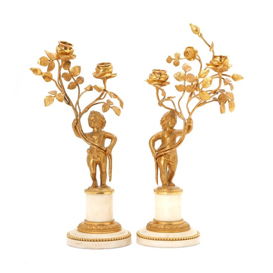 A pair of French late 18th century Louis XVI gilt bronze and marble candlesticks. H. 30 cm. (2)