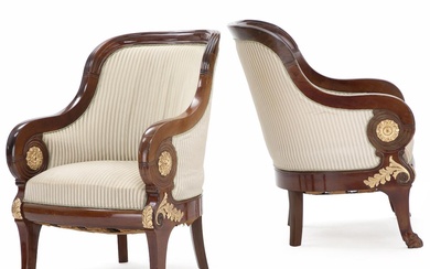 A pair of large parially gilded mahogany bergeres. Early 20th century. (2)...