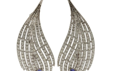 NOT SOLD. A pair of tanzanite and diamond ear pendants each set with an oval-cut...