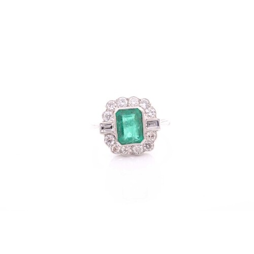 A platinum, diamond, and emerald ring, set with an emerald-c...