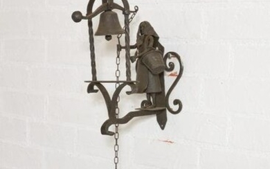 A rustic figural wrought iron bell