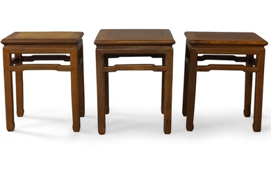 A set of three Chinese rosewood stools, 20th century, each similarly carved with a flat top set in a frame supported by four square legs with rounded corners terminating in tapered feet, joined by four humpbacked stretchers, 41.5cm x 31.5cm x 51cm...