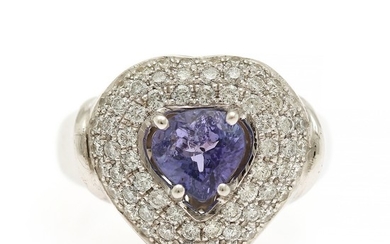 A tanzanite and diamond ring set with a tanzanite encircled by numerous diamonds, totalling app. 1.00 ct., mounted in 14k white gold. Size 57.