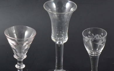 A wheel-engraved cordial glass and two wine glasses