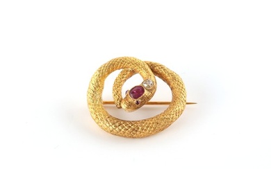 A yellow gold ruby & diamond set snake brooch, the oval cut ...