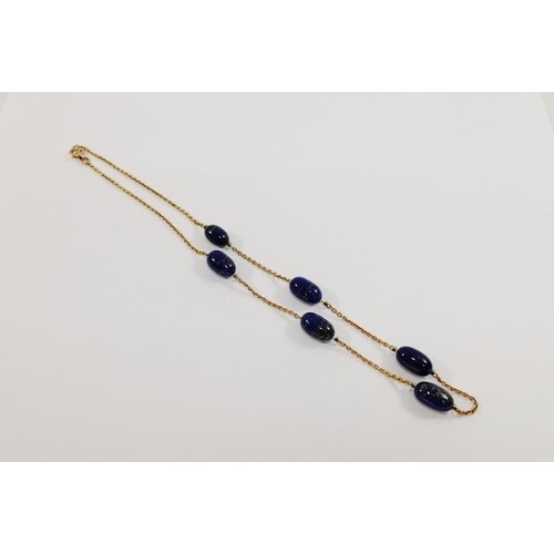 A yellow metal and lapis lazuli necklace, the chain interspe...