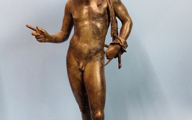 AFTER THE ANTIQUE, A BRONZE FIGURE OF NARCISSUS STANDING LOOKING DOWNWARDS HIS RIGHT FINGER