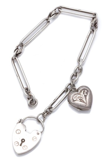 AN ANTIQUE SILVER PADLOCK BRACELET; fetter and fancy link attached with a silver front and back heart shape locket charm to an heart...