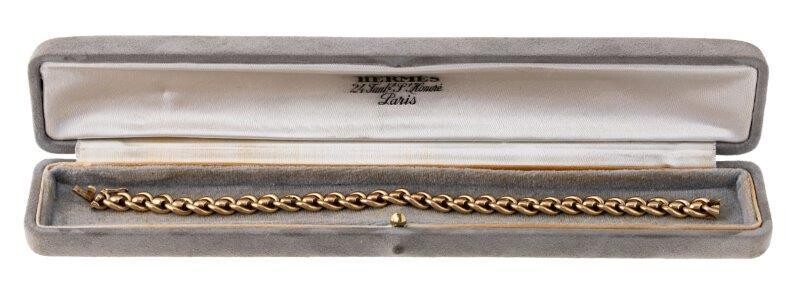 An 18ct gold bracelet, by Hermes, of fancy curb-link design, signed Hermes, French assay marks, length 19.5cm, in maker's case